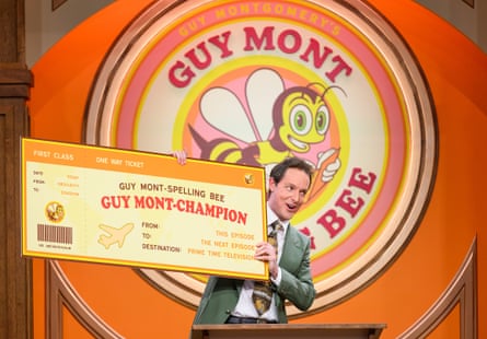 Guy Montgomery holding a large spelling bee cheque