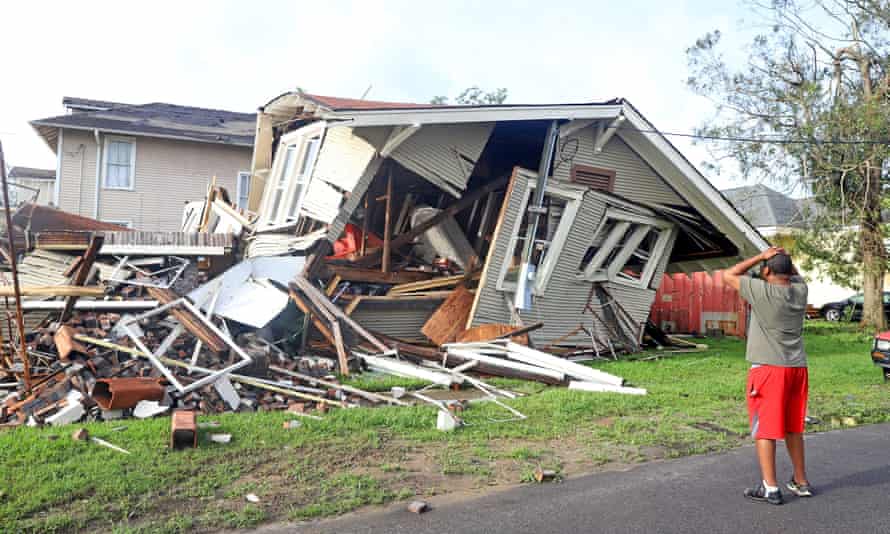 A man looks at the house that collapsed with him inside during Hurricane Ida in New Orleans.