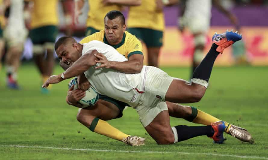 England prop Kyle Sinckler dives over for his side’s third try despite a desperate tackle attempt by Australia’s Kurtley Beale in their quarter-final at Oita Stadium.