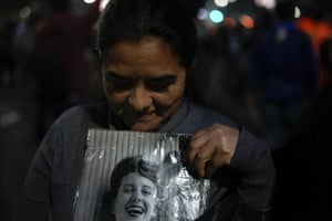 A woman holds a photo of Peron in Buenos Aires