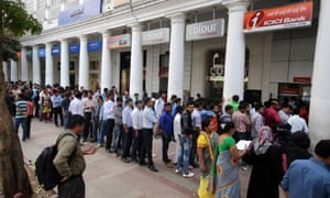 People line up to change old Indian rupee notes outside a bank in New Delhi.
