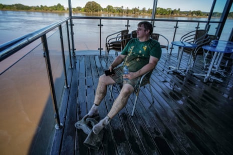 A man takes a rest amid the flooding in Taree.