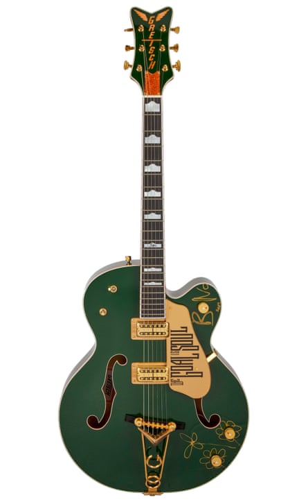 A green-coloured 6-string electric guitar
