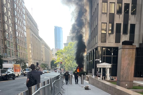 flames and smoke rise outside a building