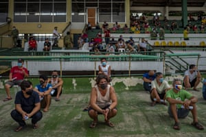Quezon, Philippines: people arrested for not wearing face masks are detained at a stadium