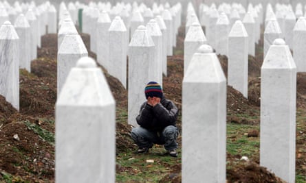 A boy weeps among the headstones of the victims of the Srebrenica massacre.