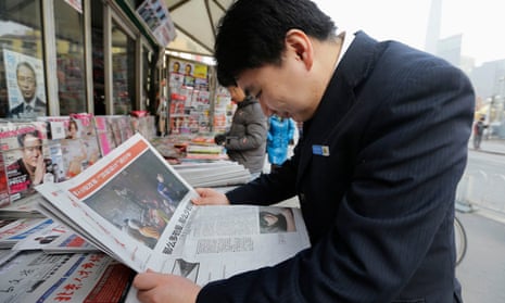 A man reads the Southern Weekly at a newsstand in Beijing