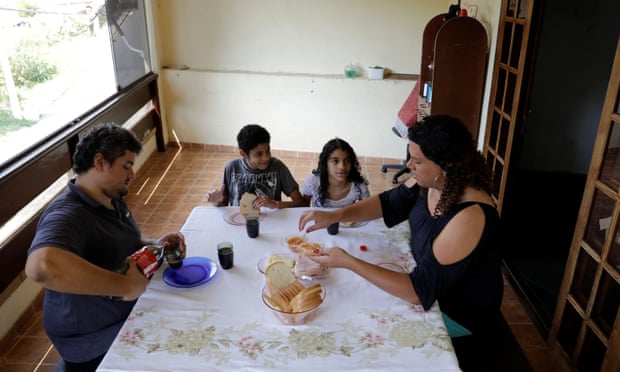 Alexya Salvador and her husband Roberto (left) with their son and daughter at home in Sao Paulo, Brazil September 2018