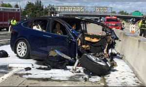 Emergency personnel work a the scene where a Tesla electric SUV crashed into a barrier on US Highway 101 in Mountain View, California.