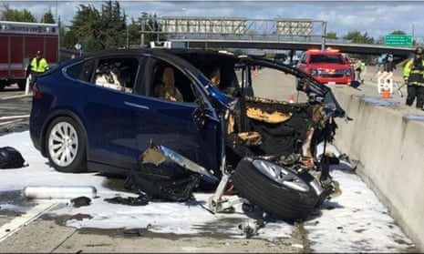 Emergency personnel work at the scene where a Tesla electric SUV crashed into a barrier on US Highway 101 in Mountain View, California.