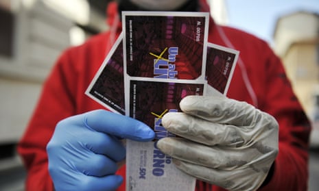 A young boy shows 4 food vouchers worth 50 Euros each printed by the Municipality of Livorno on April 4, 2020.