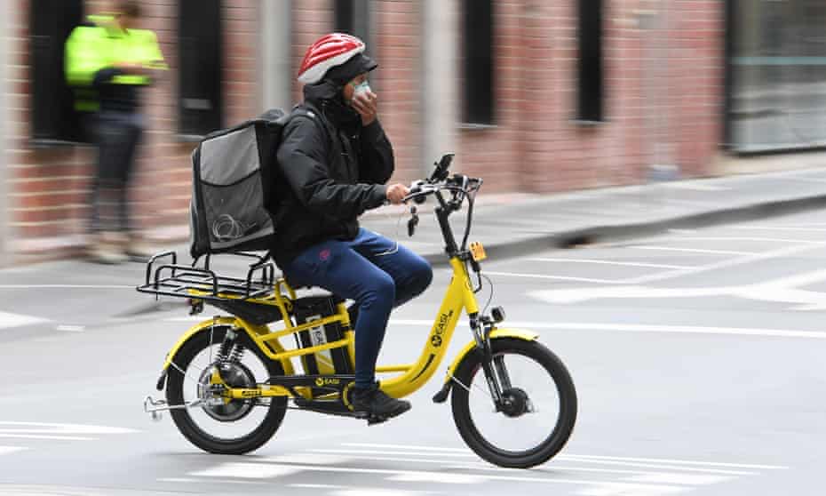 A home food delivery rider wears a mask in Melbourne after Victoria went into shutdown amid the ongoing coronavirus pandemic.