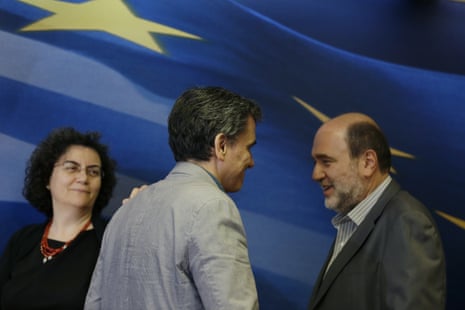 Euclid Tsakalotos, Nadia Valavani, Tryfon Alexiadis<br>Greece’s Finance Minister Euclid Tsakalotos, center, is greeted by outgoing Alternate Finance Minister Nadia Valavani, left, and the incoming Tryfon Alexiadis during the hand over ceremony in Athens, Monday, July 20, 2015. Greek banks finally reopened after three weeks of being closed but new austerity taxes meant that most everything was more expensive  from coffee to taxis to cooking oil. (AP Photo/Thanassis Stavrakis)