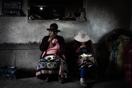Two women from the Quechua community of Chahuaytire eat their meal made up of two varieties of potatoes