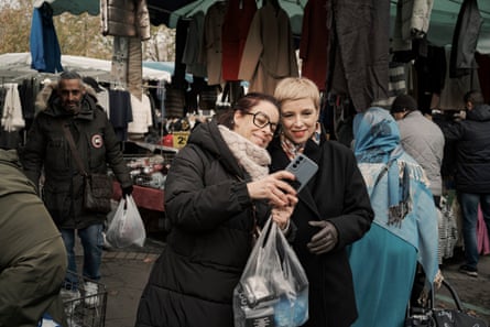 Clémentine Autain poses for a selfie with a constituent in the market at Sevran.