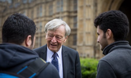 Lord Alf Dubs speaks to two refugees from Syria.