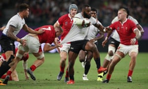 Fiji???s Semi Radradra shirt is grabbed by Wales??? James Davies as Ross Moriarty (right) looks on.