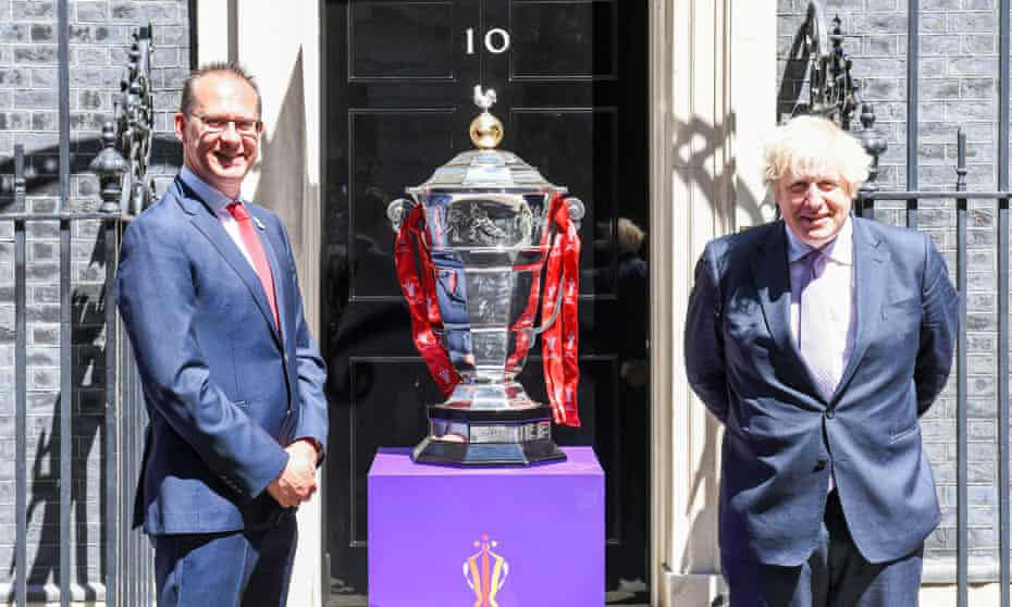 The Rugby League World Cup chief executive, Jon Dutton, and Boris Johnson promote the tournament, which has been postponed until next year.