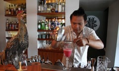 Barman Raka Ambarawan pours a cocktail at the Night Rooster bar.