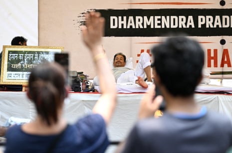 Climate activist Sonam Wangchuk gestures from a bed