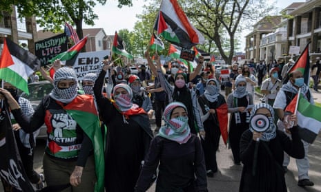 Protesters march through neighborhoods near a Ford Motor Company plant in Dearborn, Michigan, on Tuesday to protest escalating clashes between Israelis and Palestinians.