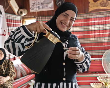 Smiling woman pouring coffee