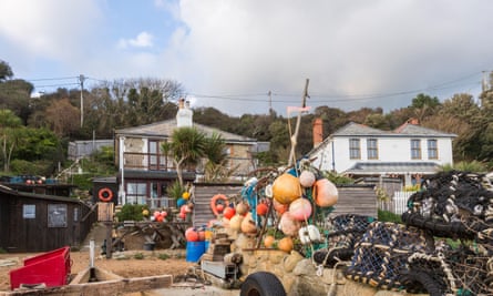 The Crab Shed with colourful buoys at Steephill Cove