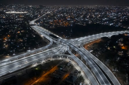 Aerial view of motorway junction at night showing glittering lights