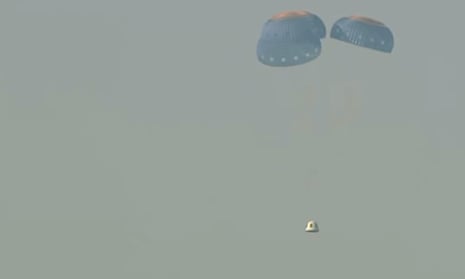 The uncrewed NS-23 capsule parachuting onto the desert floor after launch failure. 