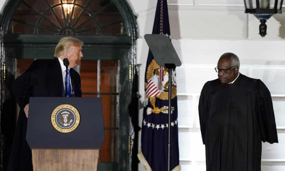 Donald Trump with Clarence Thomas as Amy Coney Barrett is confirmed to the supremne court in October 2020.