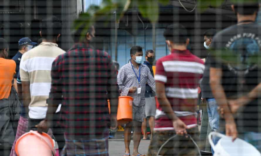 Residents queue for food at the Tuas South foreign workers dormitory that has been placed under government restriction as a preventive measure against the spread of coronavirus in Singapore on 19 April 2020.