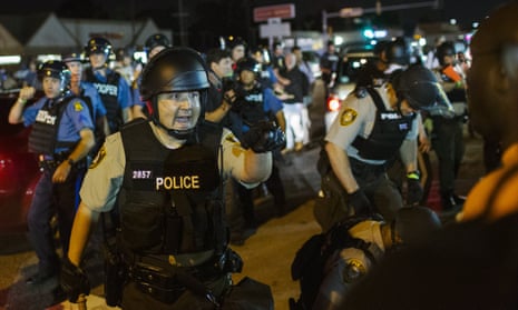 St Louis County police officers and demonstrators during protests in Ferguson.
