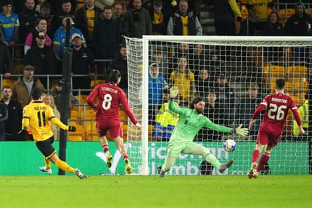 Hwang Hee-chan scores past Alisson as Dominic Szoboszlai and Andy Robertson watch
