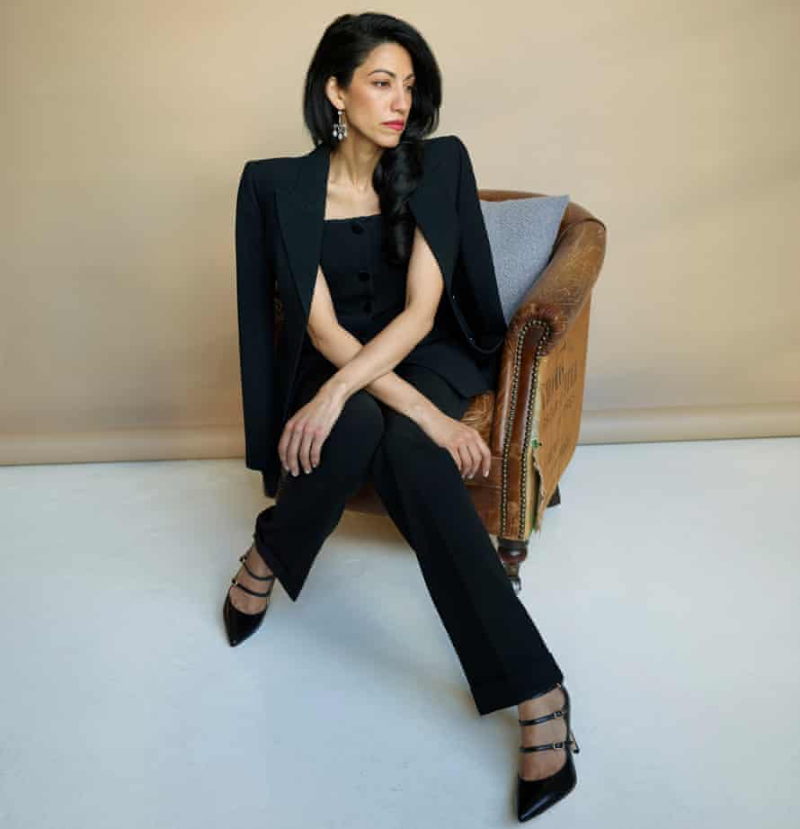 Huma Abedin sitting in chair against beige background, October 2021