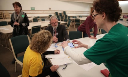 Iowa Caucus precinct workers count paper ballots after a Democratic presidential caucus at West Des Moines Christian church in West Des Moines, Iowa.