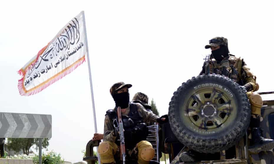 Taliban fighters patrol along a road in Kandahar in Afghanistan on 15 March, 2022. 