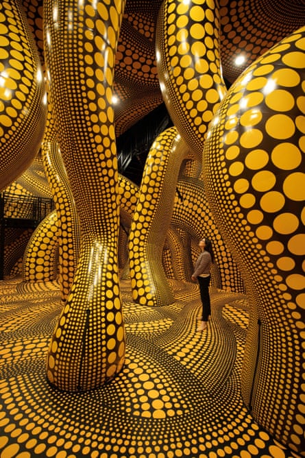 A woman admires The Hope of the Polka Dots Buried in Infinity Will Eternally Cover the Universe by Yayoi Kusama at Aviva Studios, Manchester.