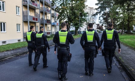 Employees of Cologne’s public order office walk through the Merheim district to check whether residents have evacuated.