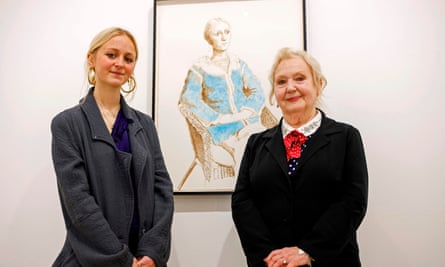 Scarlett Clark, the granddaughter of Celia Birtwell, right, beside a David Hockney portrait of Scarlett.