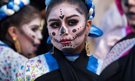 A group of young girls prepare for a performance during the Day of the Dead celebration at the Hollywood Forever Cemetery in Los Angeles, California on 28 October 2017.
