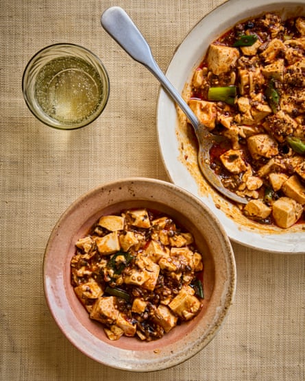 Fuschia Dunlop’s mushroom mapo tofu in bowls with a drink nearby