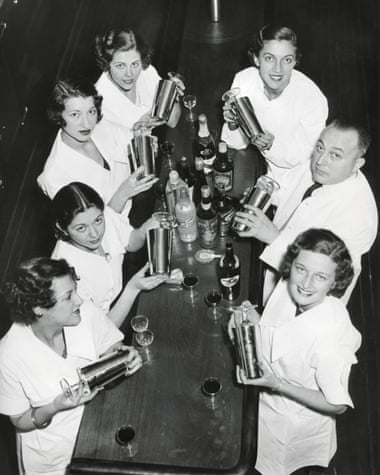 Smiling men and women with cocktail shakers at the end of prohibition.