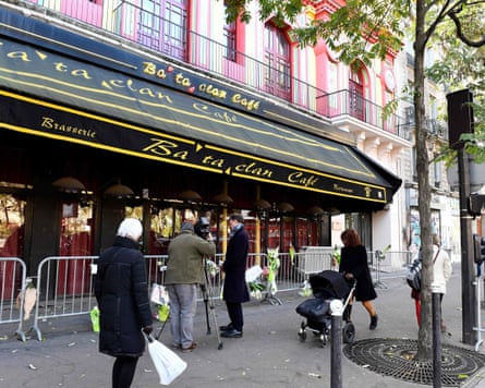 People walk in front of the Bataclan concert hall