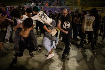 Concert goers dance and pogo at a hardcore and punk event in the city of Varginha.