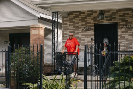 Debra Campbell poses in front of two homes that she owns