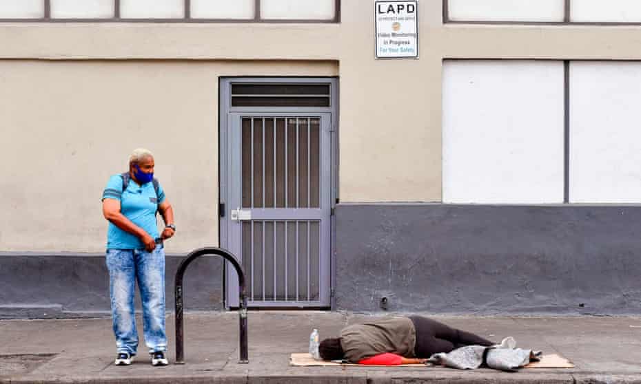 A homeless person sleeping on the sidewalk in Los Angeles, California, on 8 October 2020. 