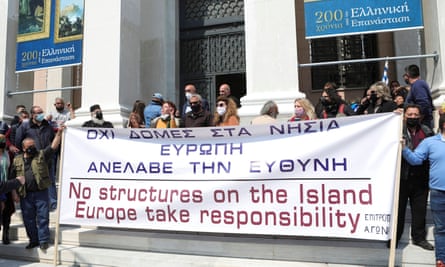 Protesters hold a banner at the town hall in Lesbos during the visit of EU home affairs commissioner Ylva Johansson to Lesbos on 29 March.