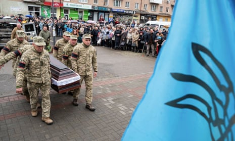 Ukrainian service members in Stebnyk in the Lviv region the carry the coffin of a soldier killed in shelling in the east.