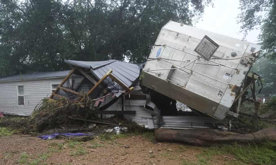 A mobile home and a truck trailer sit near a creek after they were washed away by flood waters in McEwen, Tennessee.