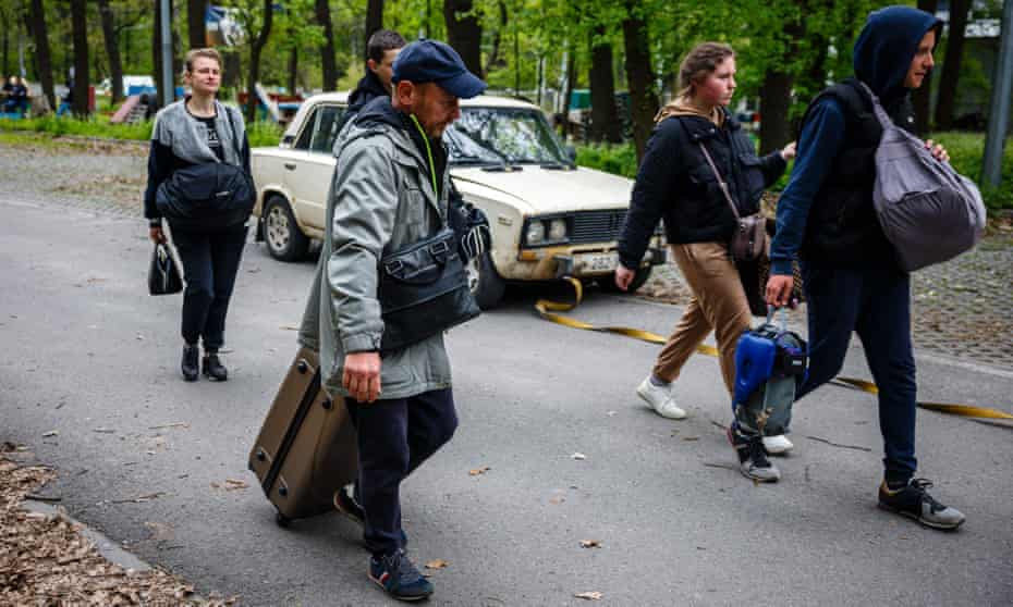 People who fled from the village of Ruska Lozova arrive at an evacuation point in Kharkiv, eastern Ukraine. The Ukrainian army is reported to have retaken the village.